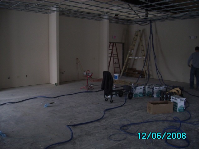 Phone and computer cabling stretched out in a meeting room.  